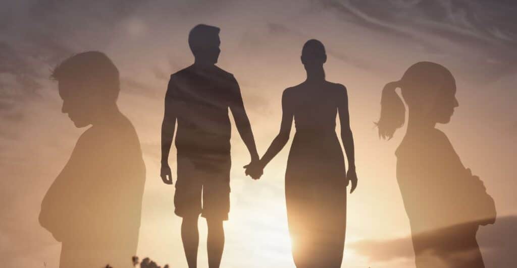 A sunset picture with the silhouette of a couple holding hands in the center and silhouettes of the couple separate on each side of the picture facing away from the couple pic, signifying the title of the article, "Can a Toxic Relationship be Saved?"