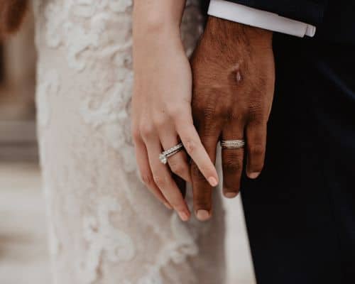 A couple's hands on their wedding day, showing their wedding rings. This photo represents how God blesses second marriages in the article titled, "Does God Really Forgive Divorce?"
