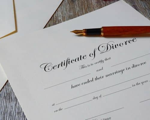 A picture of a certificate of divorce with an elegant pen on top of it. This picture symbolizes the certificate of divorce that was required for men to divorce their wives in Bible times. This photo represents the article, "Is it a Sin to Remarry After Divorce?"