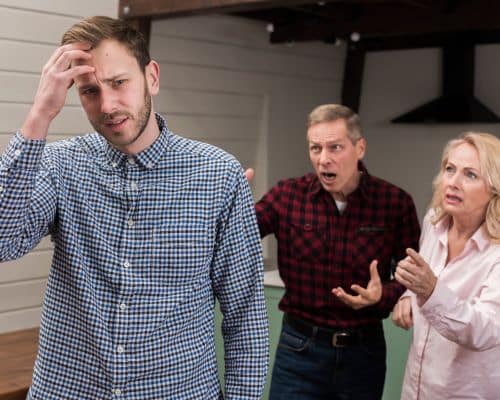 A man in the foreground on the left of the picture, looking frustrated and confused, with his hand on his head. Behind him are his elderly parents, both unhappy and nagging at him. This photo represents the title of the article, "How to Biblically Deal With a Narcissistic Parent."